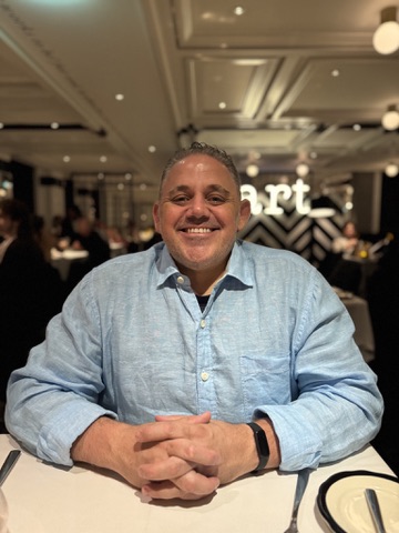 Jayson Judson seated aboard a cruise ship