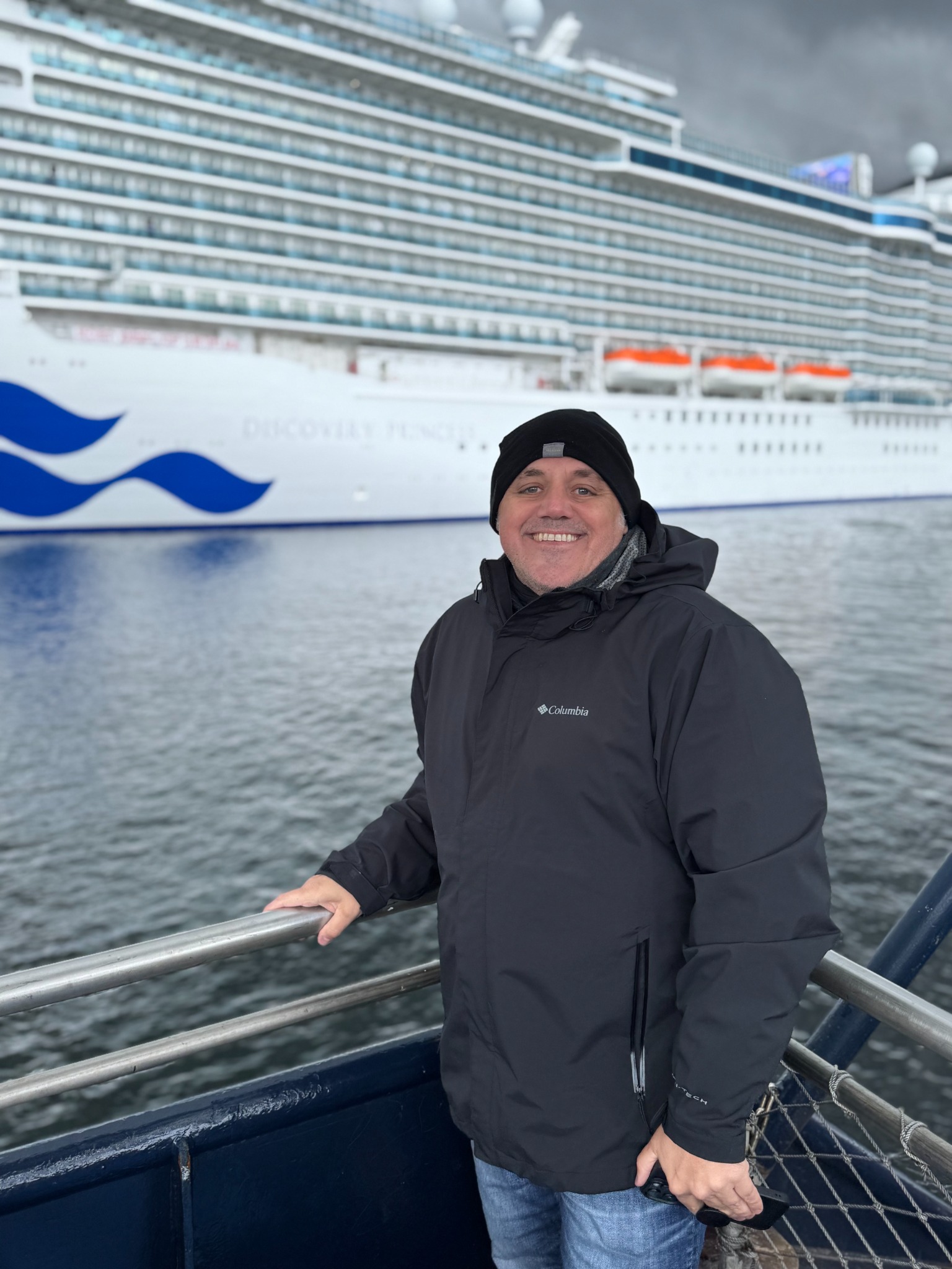Jayson Judson smiling with a Princess cruise ship behind him